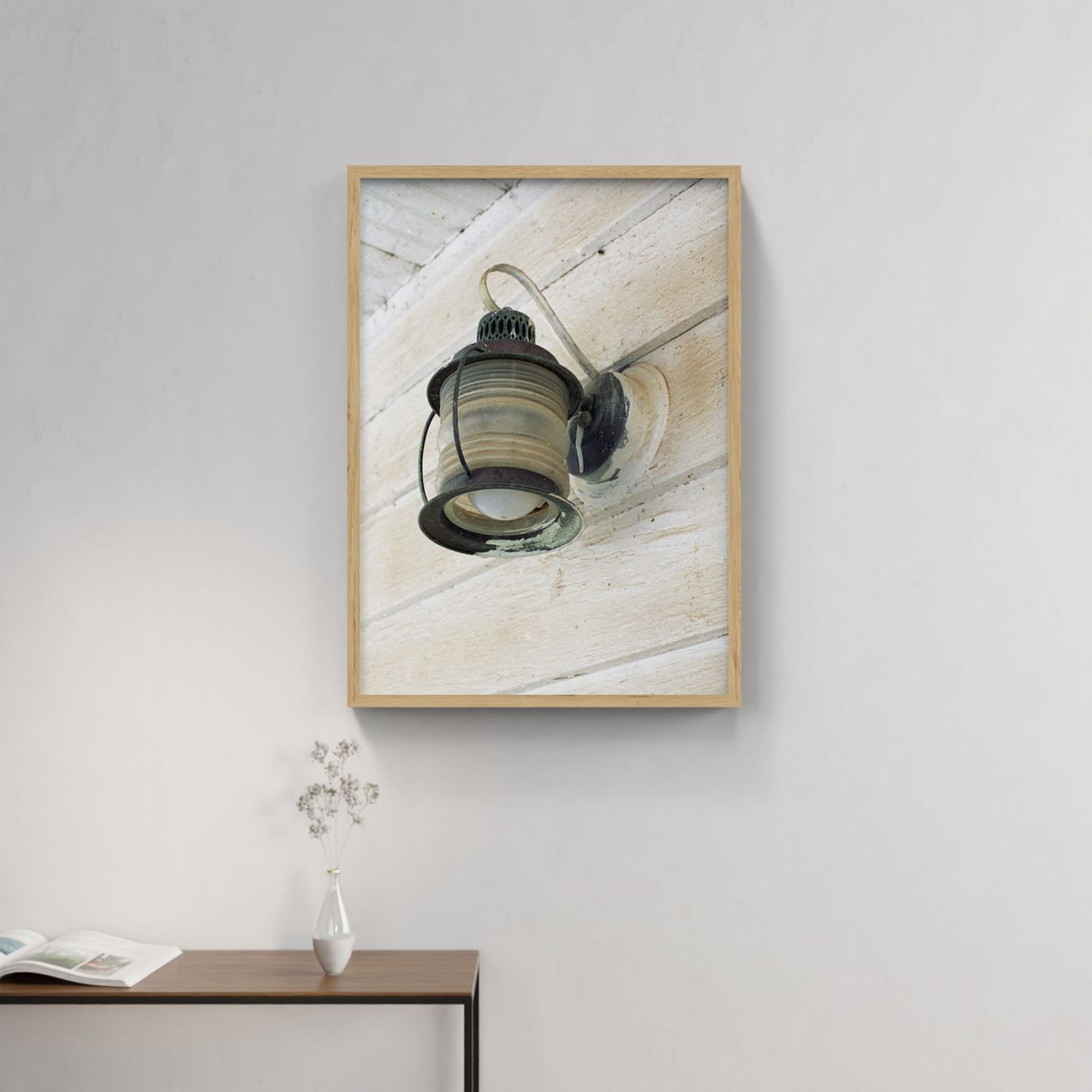 Photograph mounted in a simple frame, hanging on a neutral-toned wall in a minimalist interior space