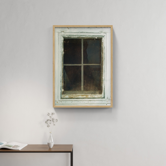 Photograph mounted in a simple frame, hanging on a neutral-toned wall in a minimalist interior space